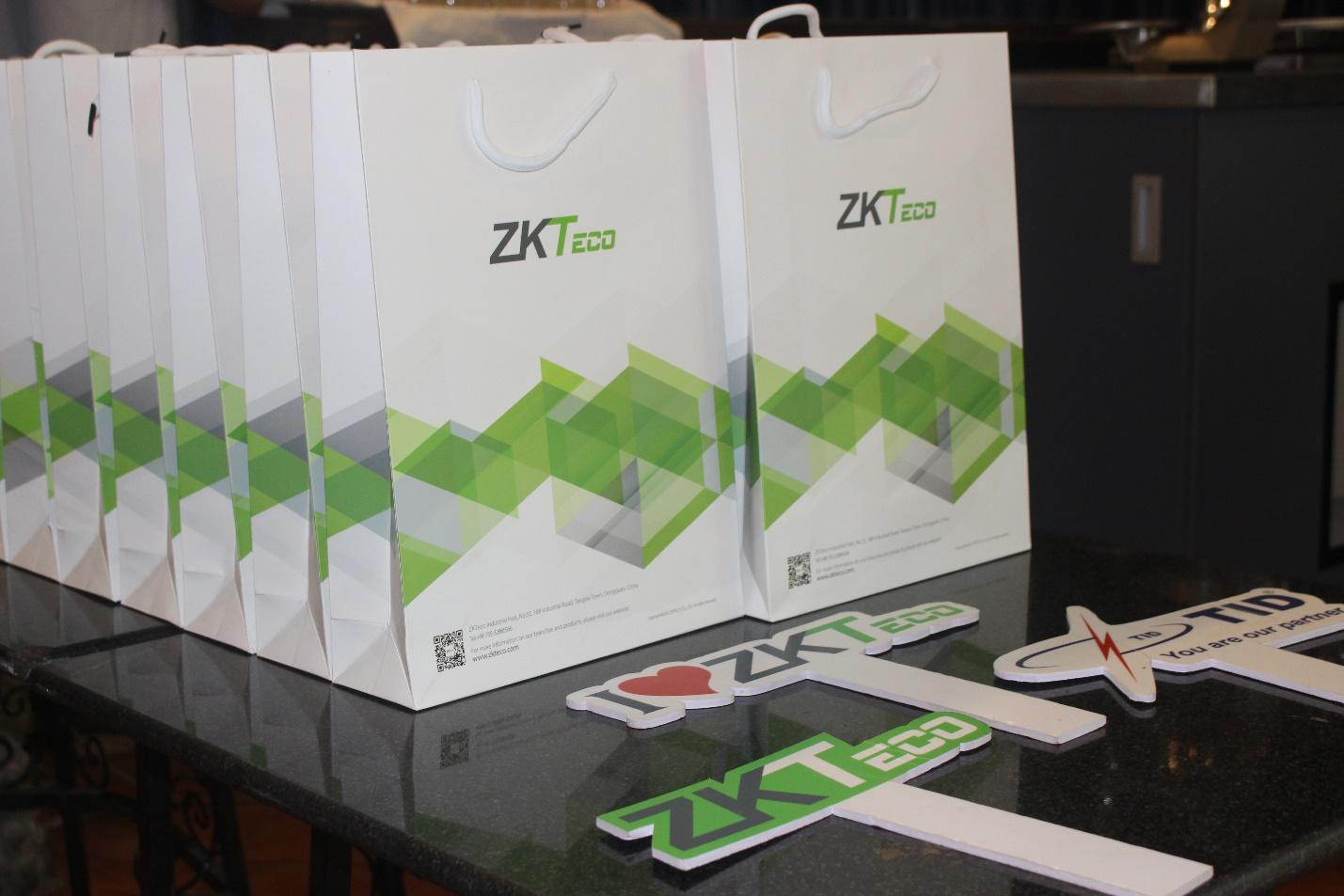Several white bags with green designs Description automatically generated